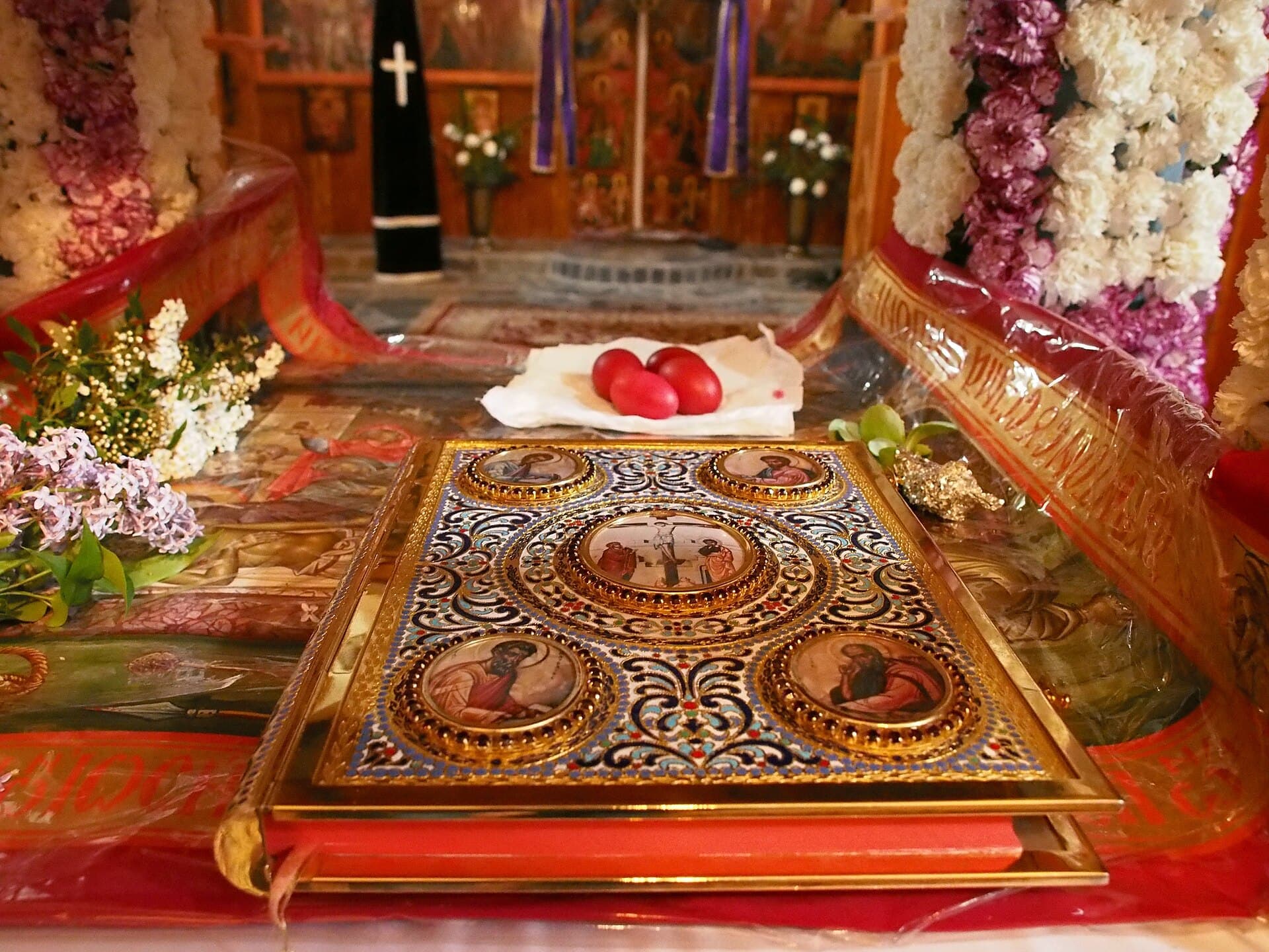 The Gospel book and red eggs on the altar at Easter