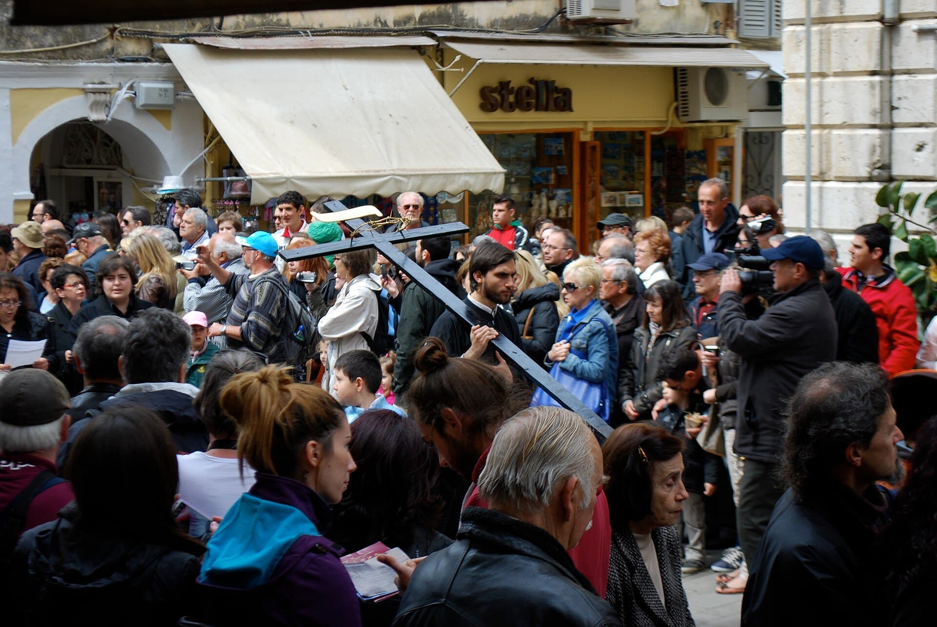 Crowds follow the Good Friday procession through the streets of Corfu