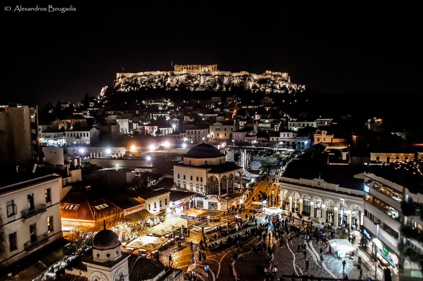 Monastiraki Square at night beneath the illuminated Acropolis