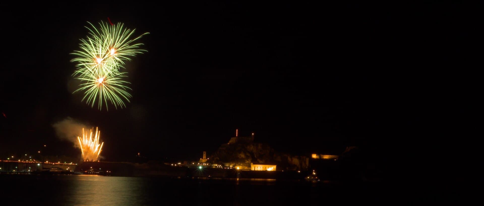 Fireworks over a Greek harbour at night