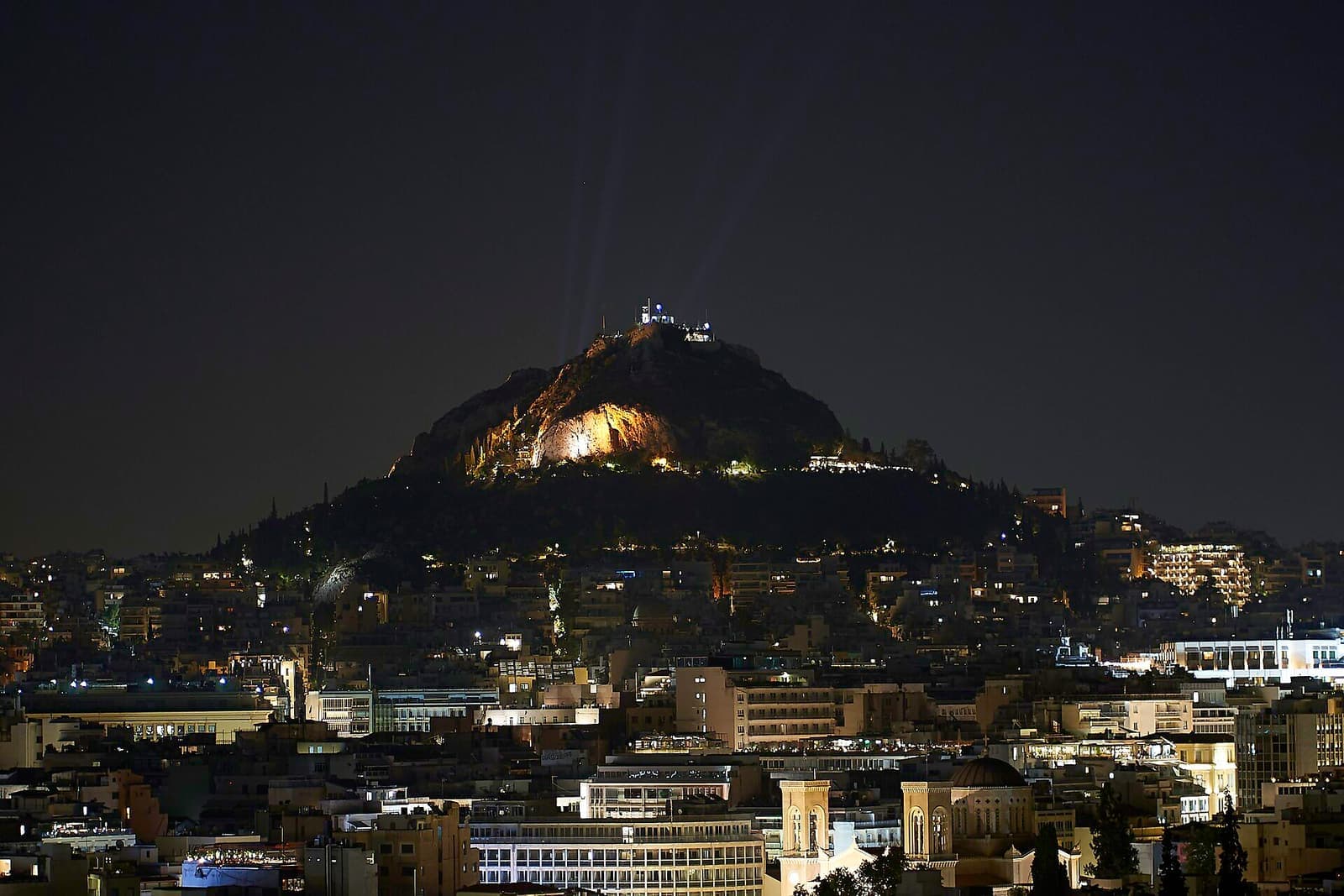 Mount Lycabettus lit up over Athens at night