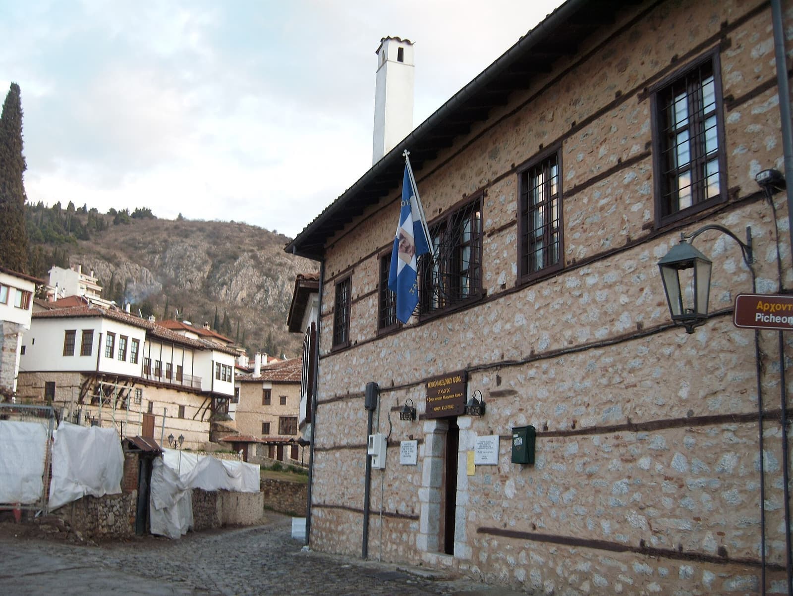 A Greek flag on a stone mansion in Kastoria