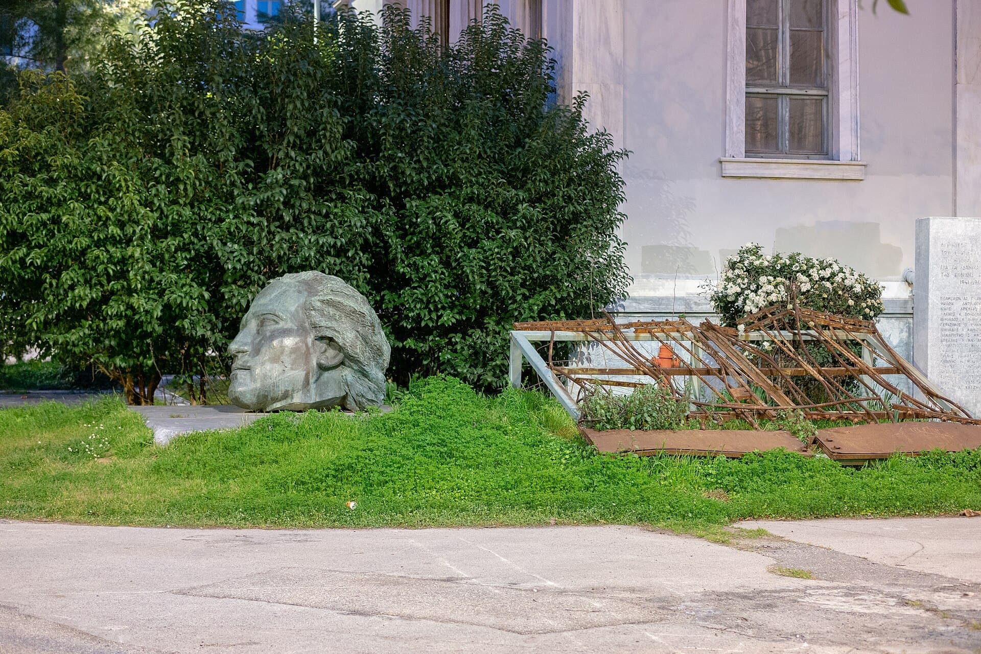 The crushed gate and marble head of the Polytechnic uprising memorial