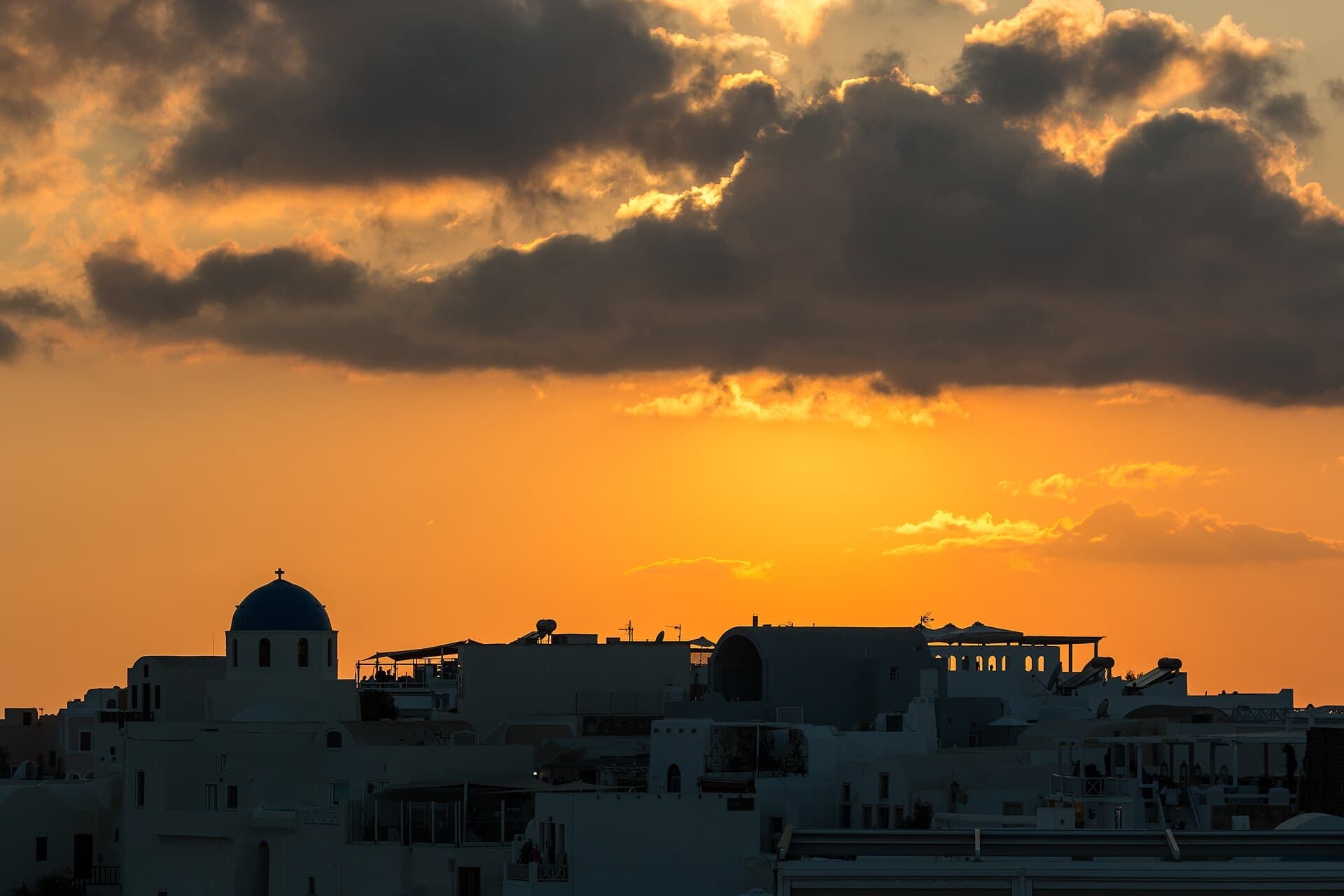 Golden sunset over the domes of Oia on Santorini